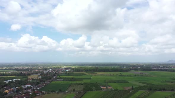 Aerial view of rural area with clear blue sky and white clouds