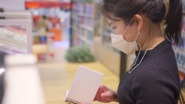 New normal after covid epidemic young smart asian female shopping new lifestyle in supermarket alt
