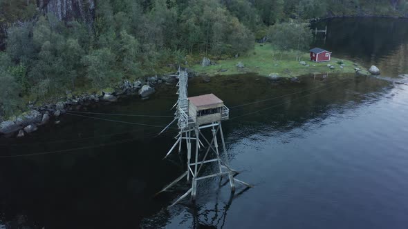 Aerial shot over Old salmon fishing hut in the middle of lake - Laksegilje, Norway alt
