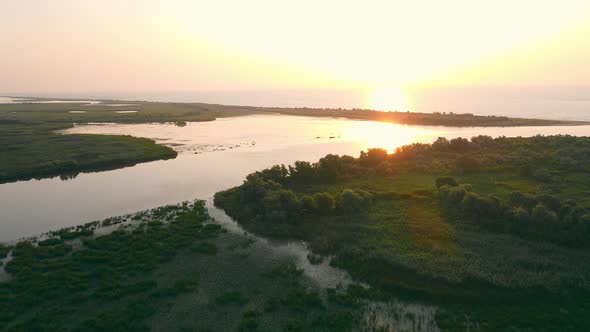 Beautiful Scenery of Wide River at Sunset with Reflection on Water alt
