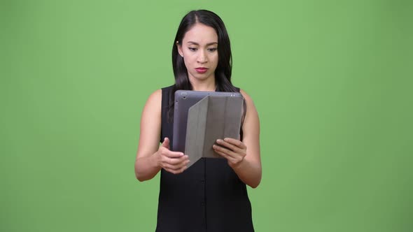 Young Beautiful Asian Businesswoman Using Digital Tablet alt