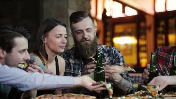 A Company of Happy Friends at a Cafe Table Eat Pizza Drink Beer and Have Fun alt