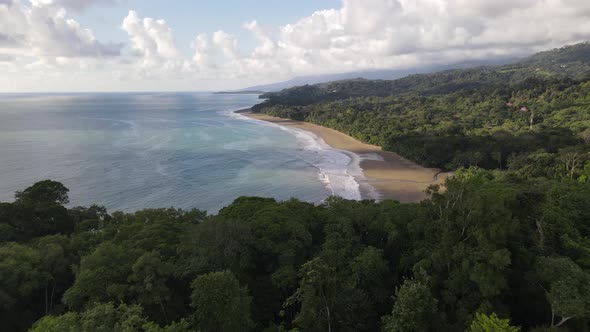 Aerial view of a beautiful empty Costa Rican coastline with sand beach alt