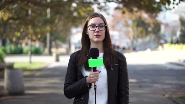 Girl Journalist Is Reporting on the Street