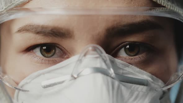 Portrait of Confident Doctor Woman Face, Close-up. Eyes with Safety Glasses and Protective Mask alt