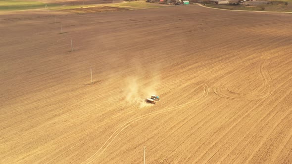 Aerial View. Tractor Plowing Field In Spring Season. Beginning Of Agricultural Spring Season alt