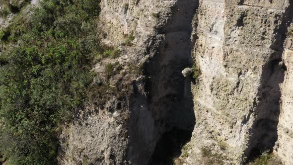 A large cliff and the surrounding environment in the andean mountains alt