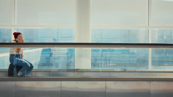 Woman Chat on Phone with Friend in Empty Airport alt
