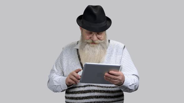 Old Retired Grandpa Starting Online Conversation Using His Tablet Pc alt
