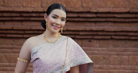 Portrait of Thai woman salute of respect in traditional costume of thailand alt