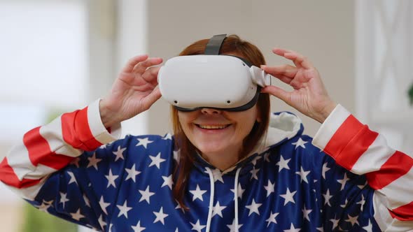 Excited Joyful Mature Woman in VR Headset Smiling Gaming Online in Augmented Reality alt