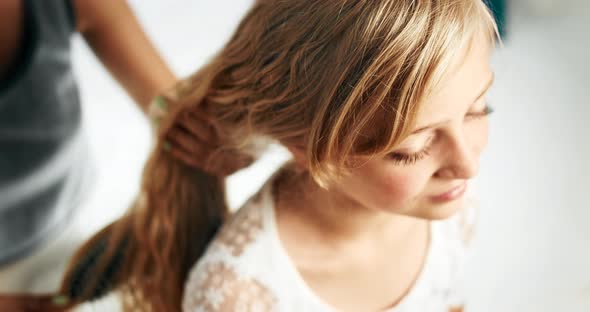 Mother Combing Girl Hair