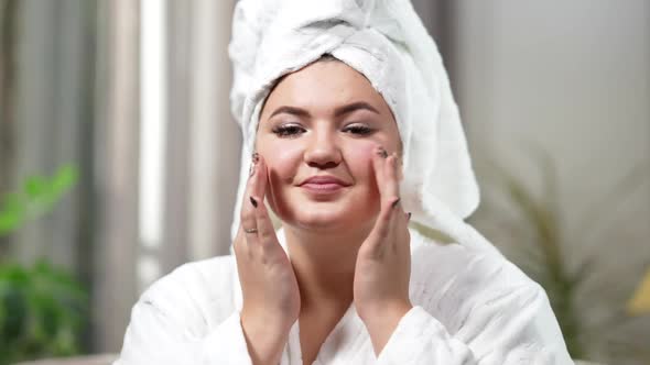 Portrait of Young Smiling Woman Touching Face Looking at Camera alt