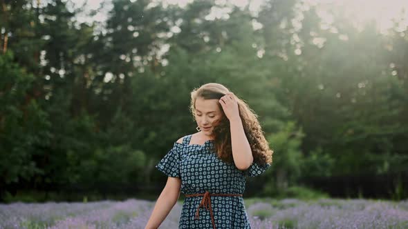 Goodlooking and Happy 30Aged Woman with Natural Beauty Walking Down Lavander Field Turns to Camera