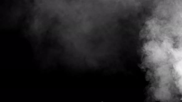 Soft fog in slow motion on dark background alt