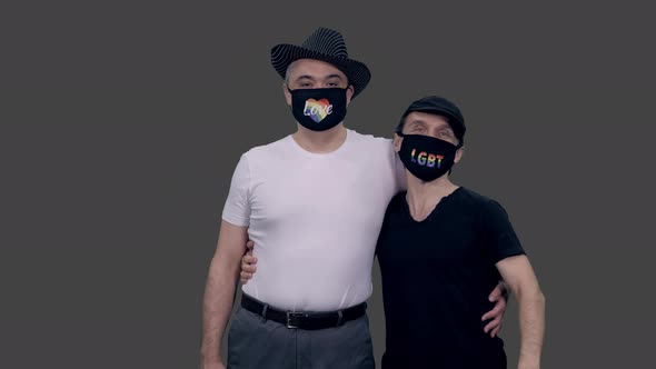 Two Adult Gay Men in Anti Covid Masks with Lgbt Symbols, Alpha in