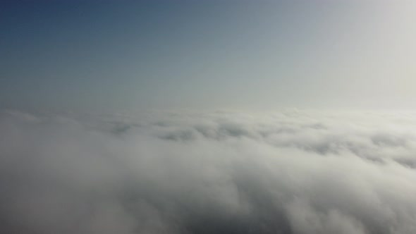 High Above the Thick Fog Like Beautiful Ocean of Clouds at Sunrise alt