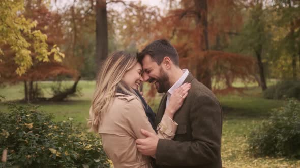 Handsome young couple walking in the autumn park