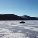 Drone Aerial View of Car in Winter Landscape and Hi Speed Driving Over the Frozen Lake - VideoHive Item for Sale