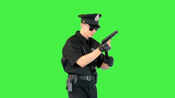 Policeman Walks Doing Some Exercices with His Gun on a Green Screen Chroma Key