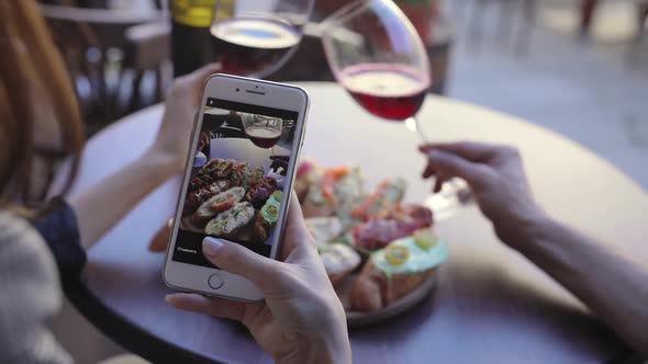 Closeup Woman Taking Photos Of Food And Wine In Restaurant. alt