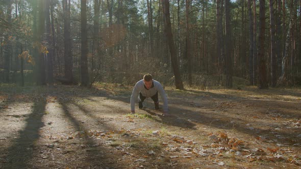 Young Man Is Doing PushUps In Forest