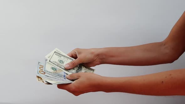 Close-up View of Young Female Hands That Are Counting Dollar and Euro Bills. The Girl Is Holding a alt