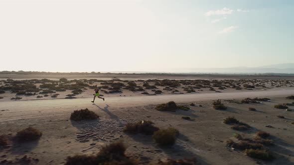 360 Degrees Aerial Moving Shot of Man Running Outdoors in Nature