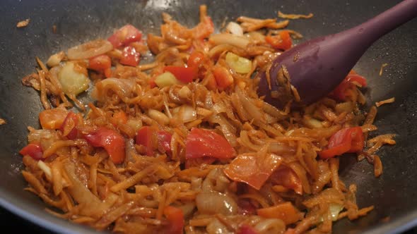 Frying vegetable mix in hot oil close-up 4K 2160p 30fps UltraHD footage - Wok with bulb onion and gr alt