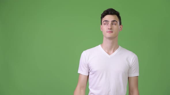 Young Handsome Man Thinking While Pointing Finger Up alt