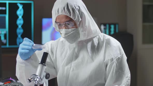 Doctor In Protective Suit Is Doing A Science Experiments And Developing Vaccine In A Modern Lab alt