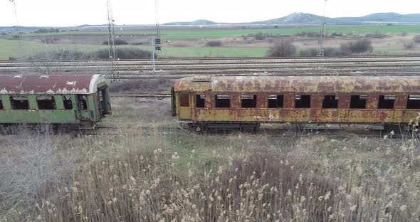 Aerial view of abandoned old railway wagons at station. Old train wagons alt