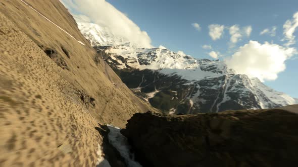 Drone Shot Down a Waterfall Along the Mountain Dew Towards to Beautiful Valley alt