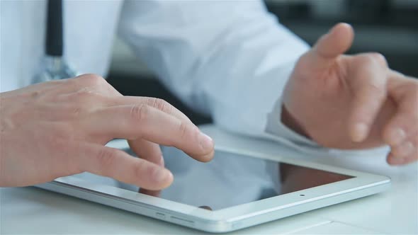 Doctor Using Digital Tablet And Pointing Into Touchscreen
