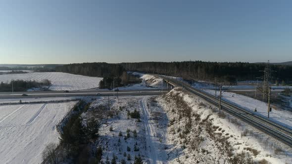 The camera flies over the railway and approaches the highway alt