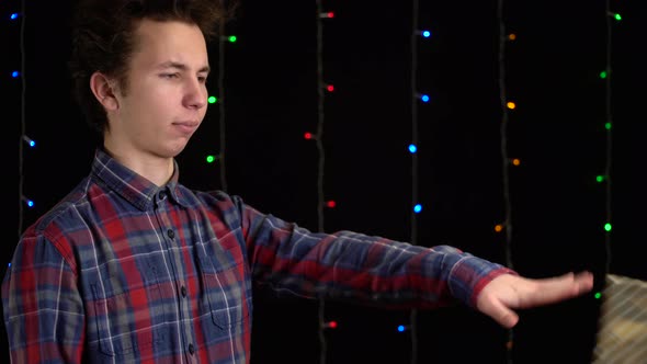 Boy with a Gift Box on Black Background,Gift Box with Ribbon for Happy New Year, Merry Christmas alt