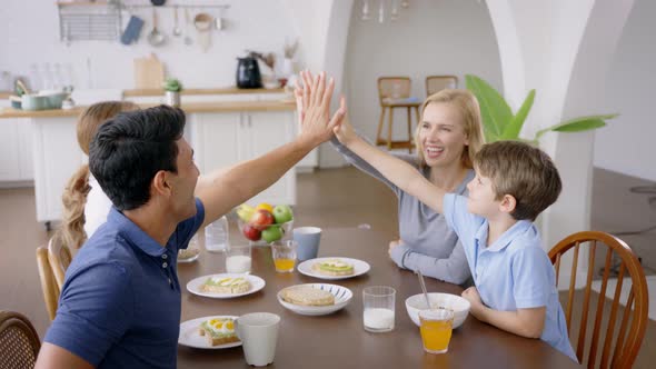 Family Giving Highfive During Breakfast alt