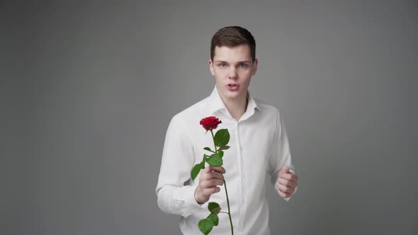 An Elegant Man in a White Shirt Wants to Sell a Flower
