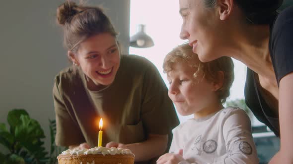 Little Boy Celebrating Birthday with Lesbian Mothers at Home alt