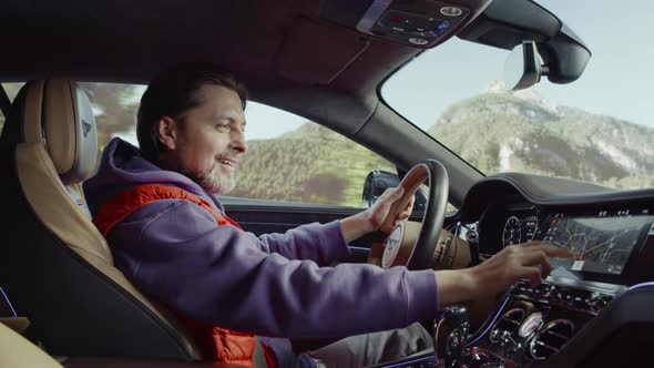 The driver driving the car looks at the map with a smile.