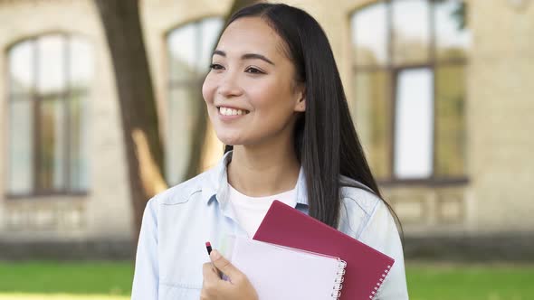 Portrait of Asian Student Girl Outdoors, in The Park Near the College