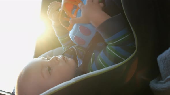 Toddler Boy Traveling in a Car Sitting in a Child Safety Seat alt