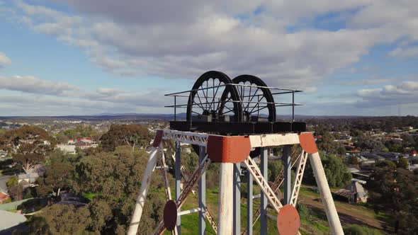 Close-up circling drone shot of Victoria Hill Mining Reserve poppet head in Bendigo alt