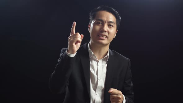 Close Up Of Asian Speaker Man In Business Suit Showing Index Fingers Up ...