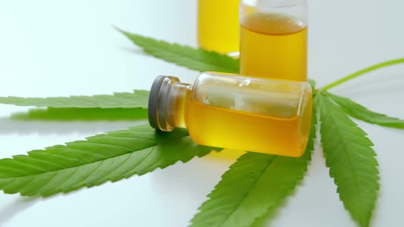 Cannabis oil in the vial with green leaf. Alternative medicine concept. alt