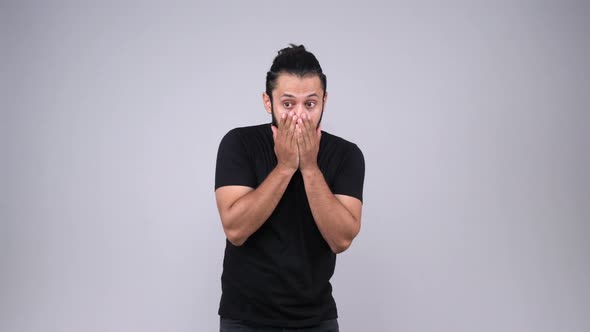 Depressed Indian young adult shocked or devastated by something alt