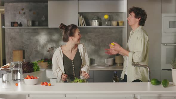 Cheerful Couple Cooking Dinner Together on Kitchen