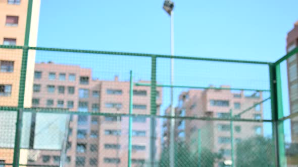 Young Tennis Player Serves and Hits the Ball with a Racket
