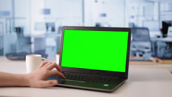 Man Working on Green Screen Laptop