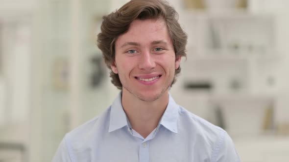 Portrait of Happy Young Businessman Smiling at Camera alt